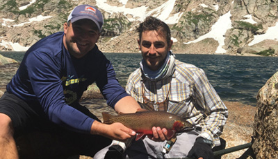 Two men holds a Cutthroat Trout caught in Rocky Mountain National Park