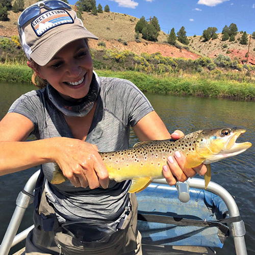 Women holds brown trout caught in the Colorado River