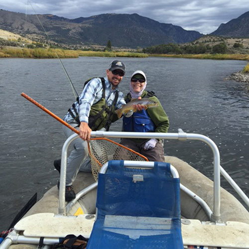 Two anglers hold trout while float fishing on the Colorado River