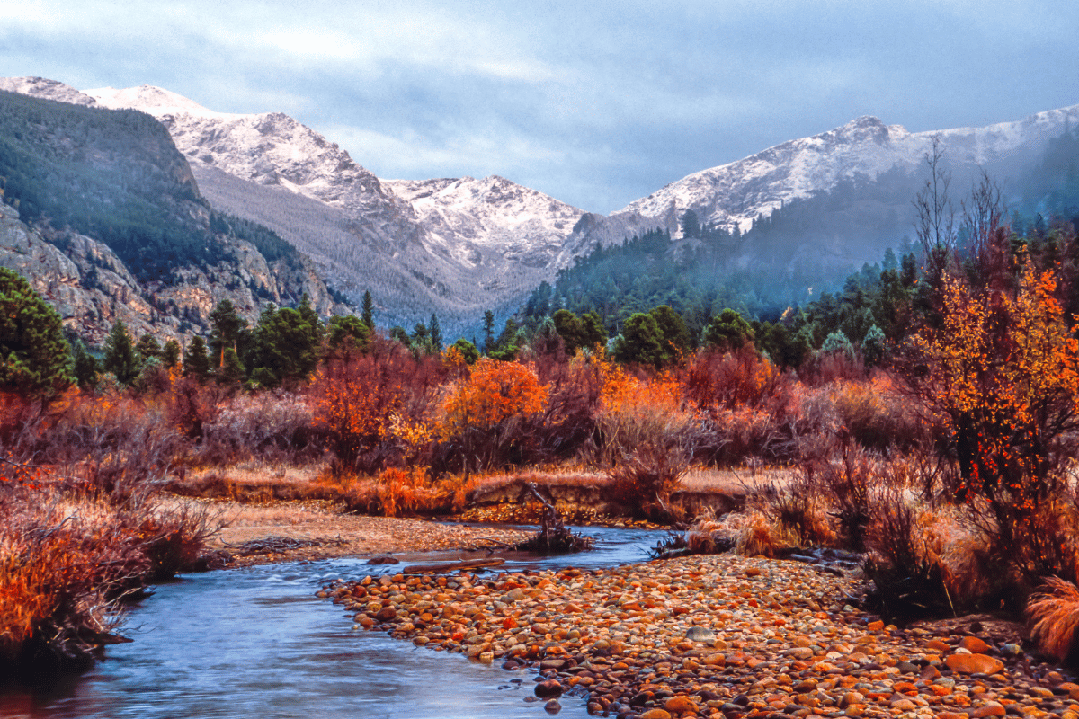 Big thompson river with snowy mountains behind.