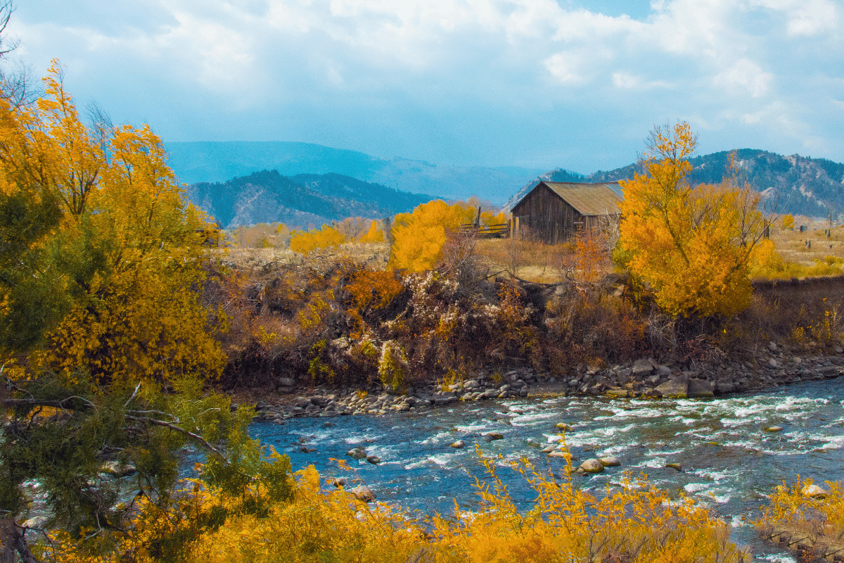 Eagle river with fall colors and a cabin on the side.