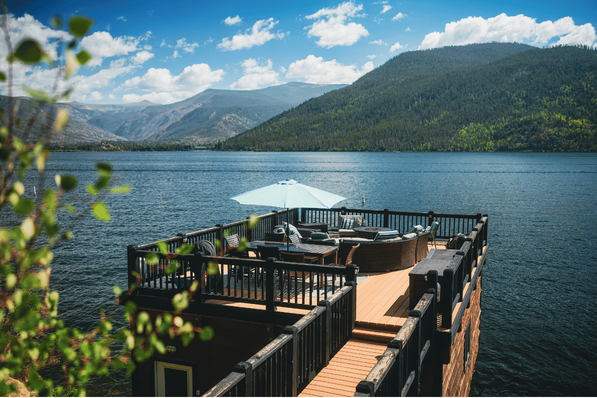 A dockside patio extends over grand lake colorado.